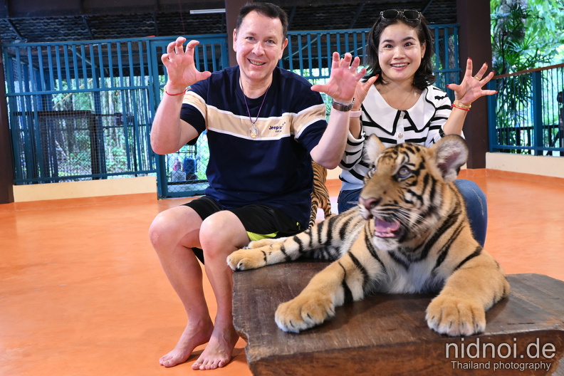 posing with small tiger